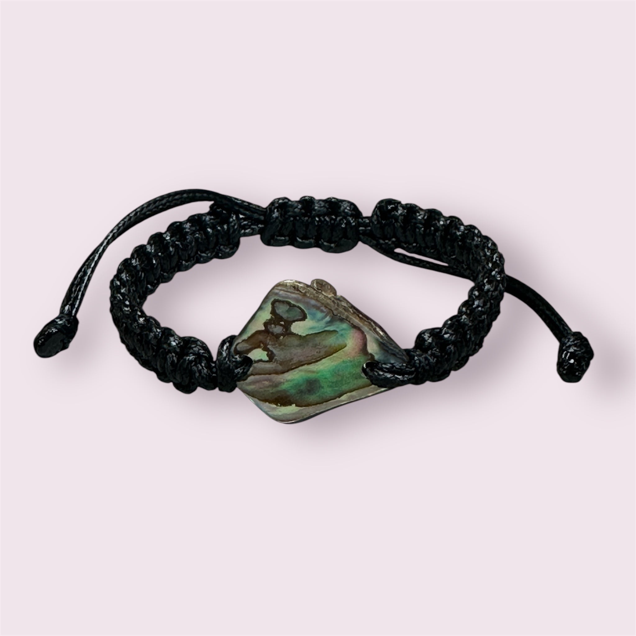 Black knotted polyester bracelet with a genuine New Zealand Paua shell centrepiece on a white background.