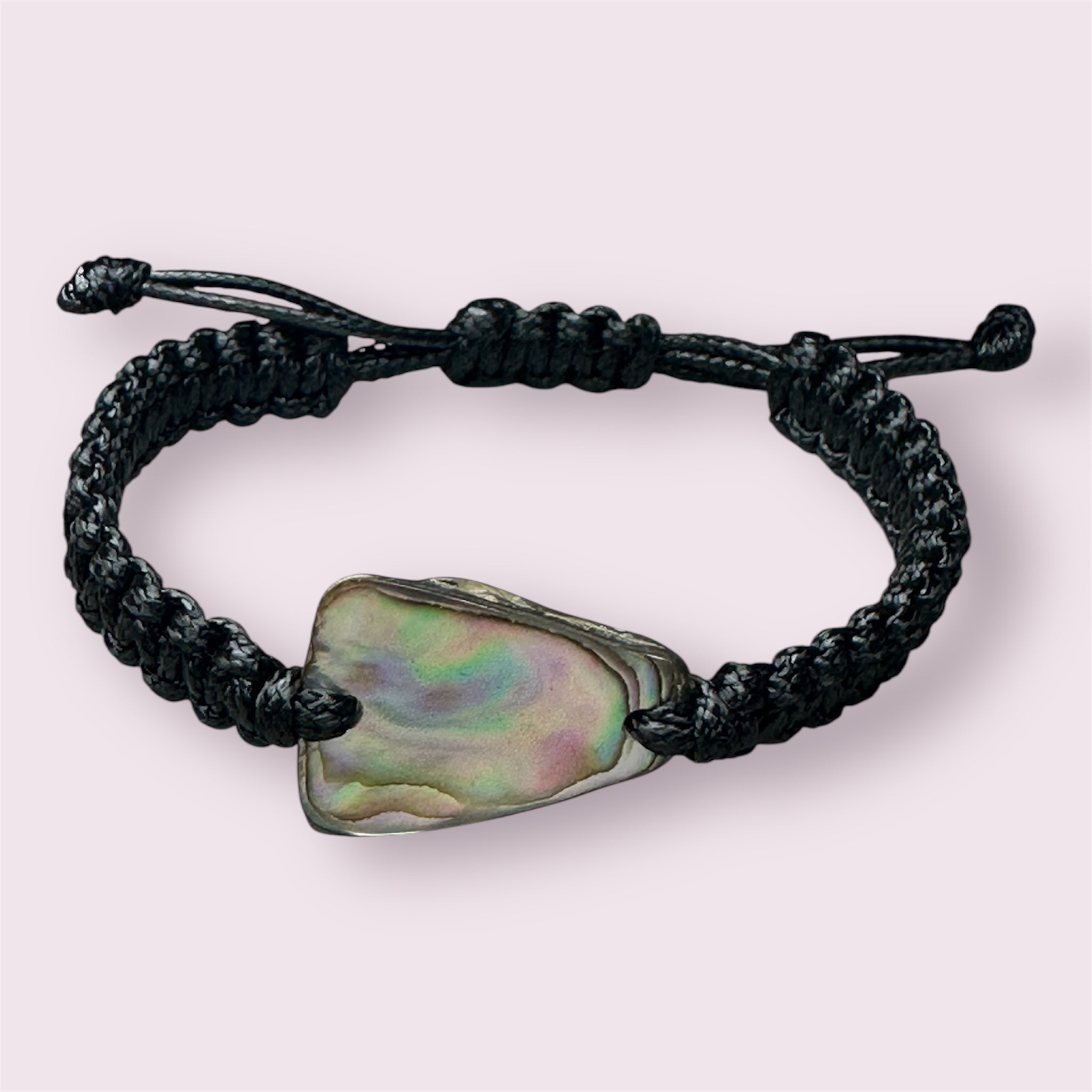 Bracelet made of durable black cord featuring a genuine Paua shell from NZ waters.