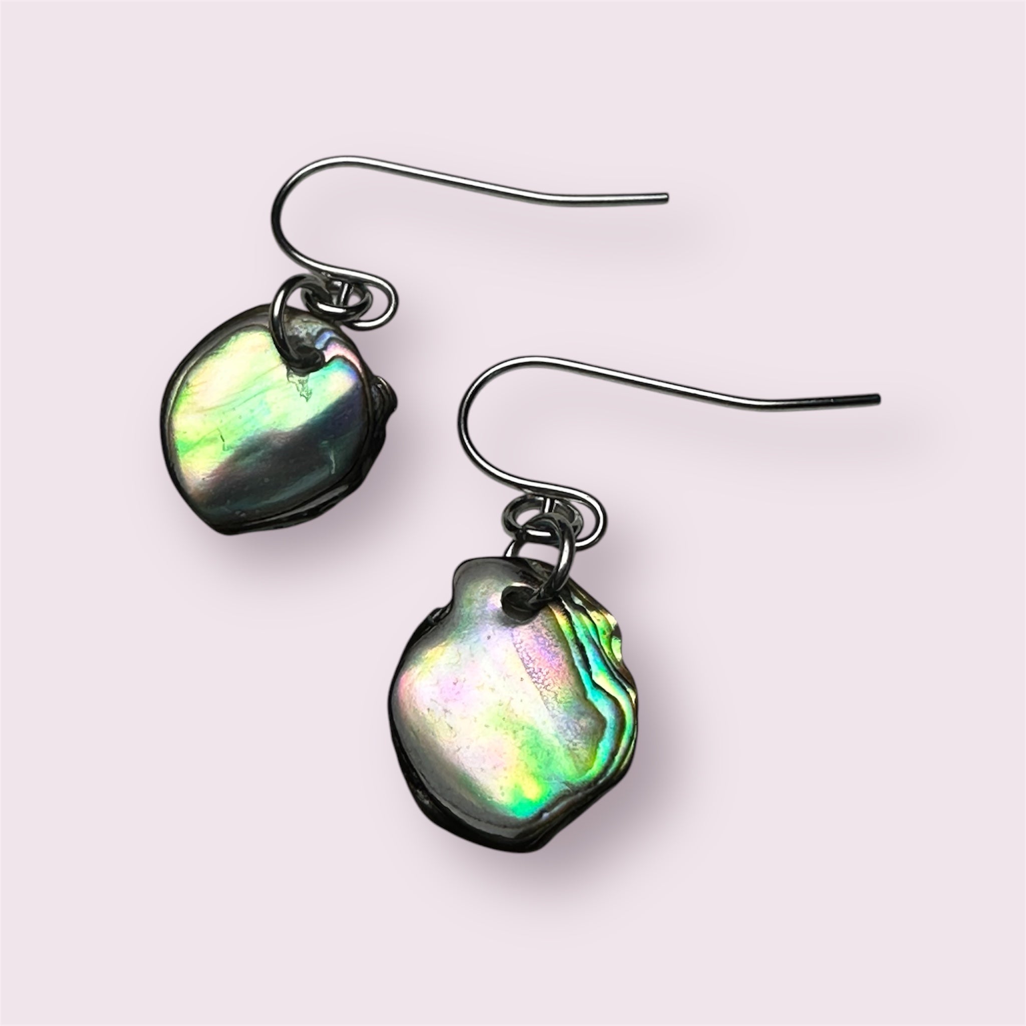 Close-up of shimmering Paua shell in stainless steel earring setting