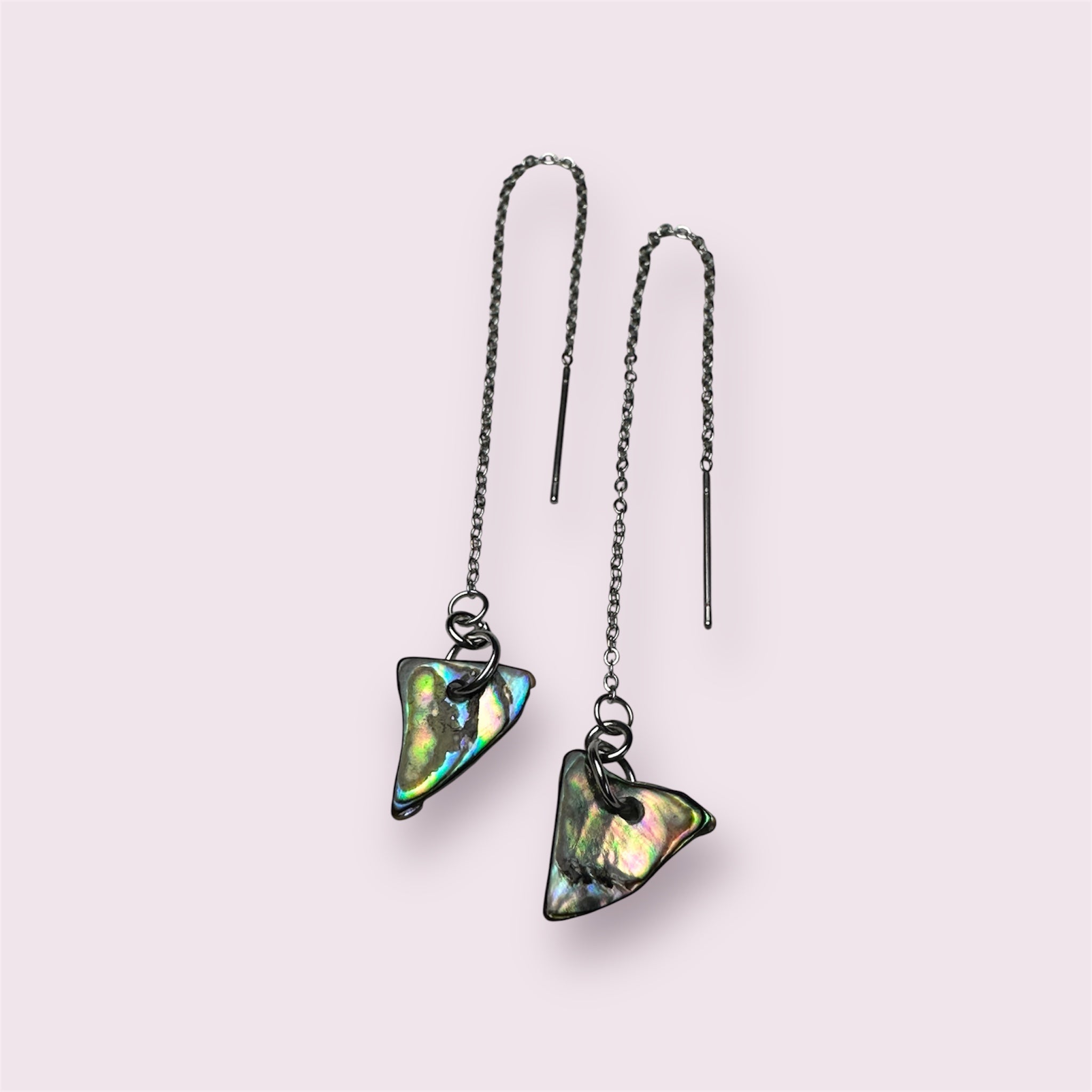 Close-up of thread-through Paua shell earrings in stainless steel